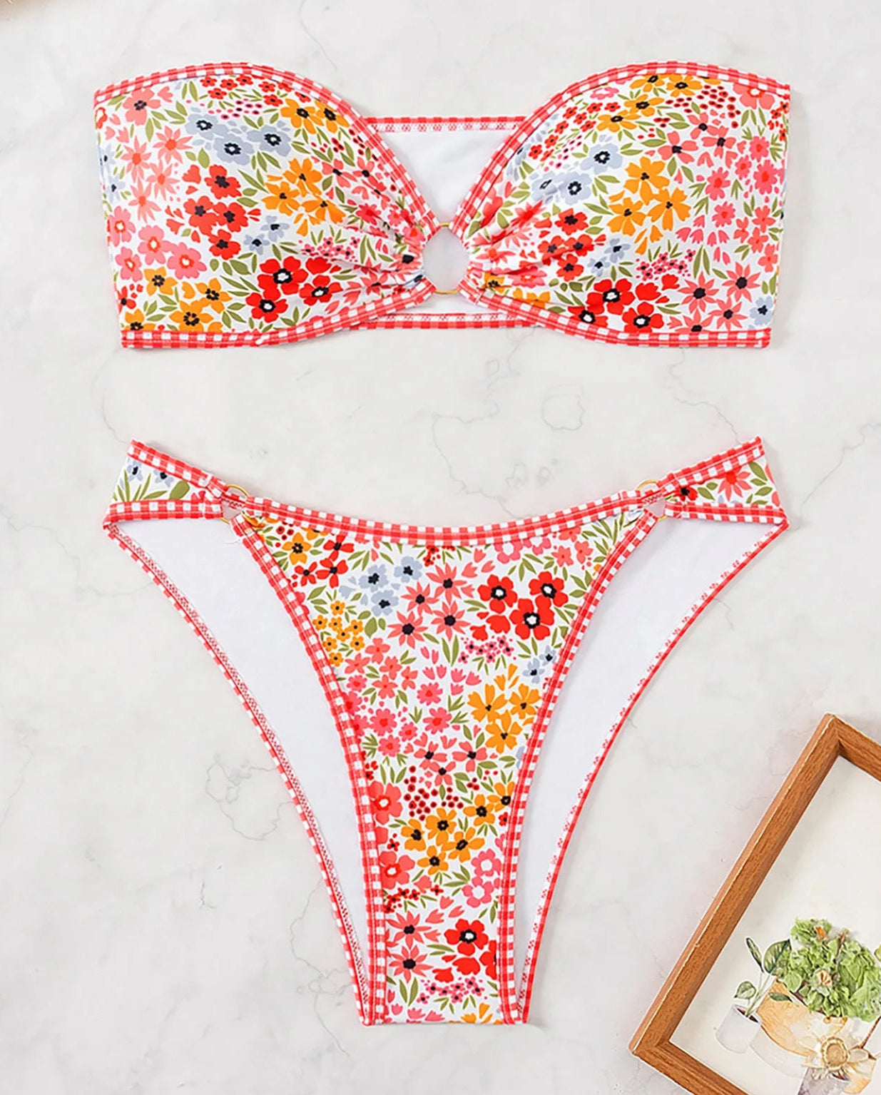 Bikini bandeau coques CELIA with floral pattern and Brazilian tanga cut. Perfect for chic summer looks | SuzzaneMarket.
