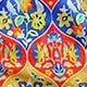 Colorful floral pattern in blue, red, and yellow tones, featuring intricate designs | SuzzaneMarket