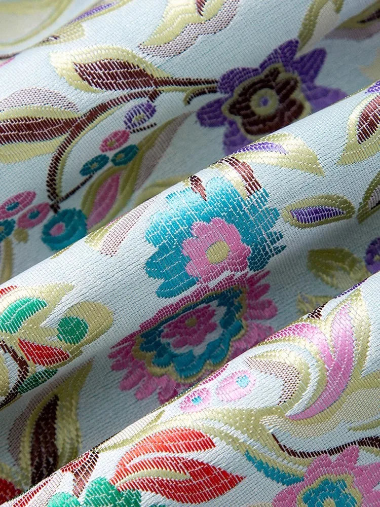 Close-up of floral jacquard fabric in pastel colors, featuring intricate designs and textures | SuzzaneMarket