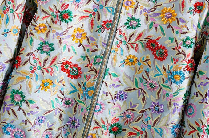 Close-up of floral jacquard fabric with colorful embroidery on a bomber jacket | SuzzaneMarket