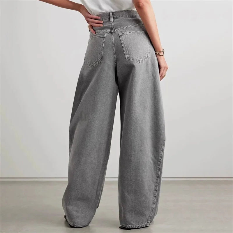 Back view of large banana cut denim jeans in grey, featuring high waist and wide legs. | SuzzaneMarket