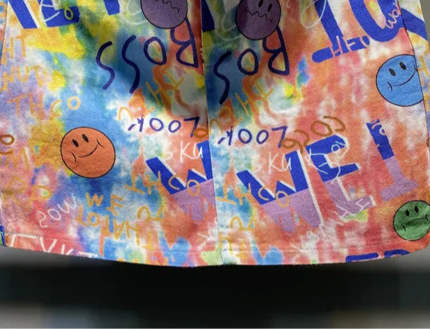 Colorful denim print fabric featuring smiley faces and playful text, ideal for a trendy summer look |SuzzaneMarket