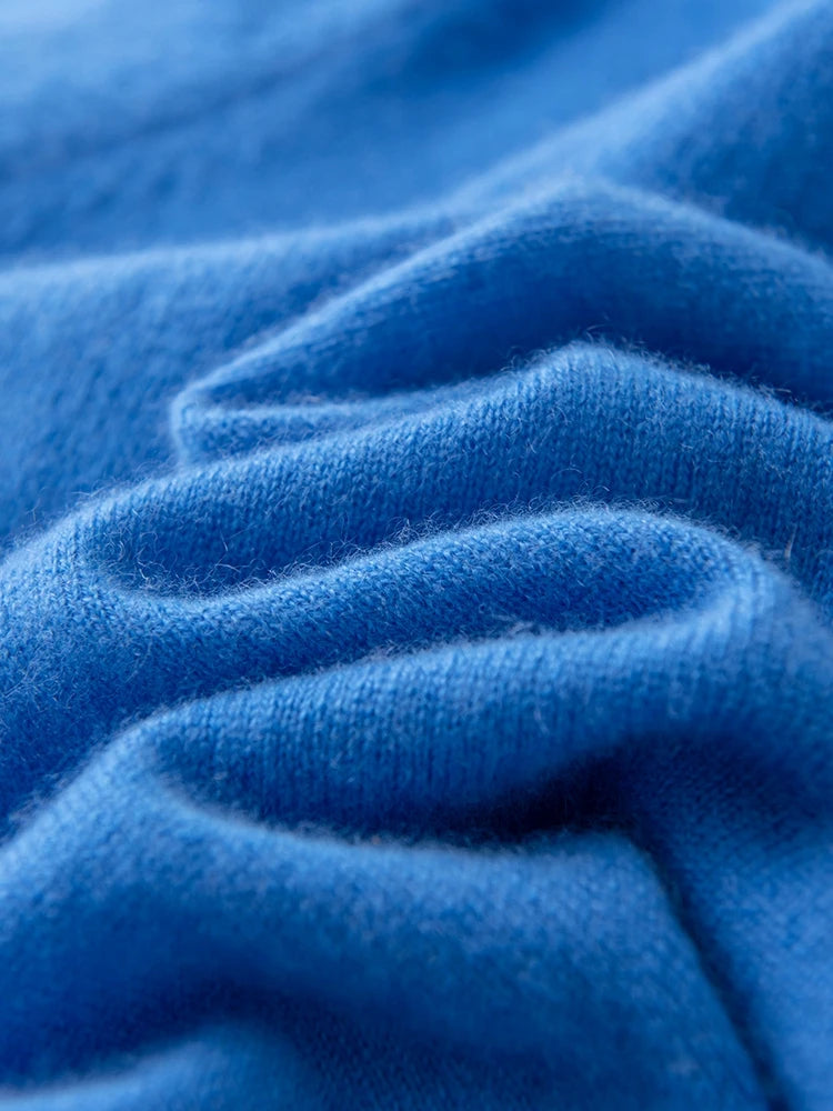 Close-up of soft blue cashmere fabric, showcasing its luxurious texture and quality | SuzzaneMarket