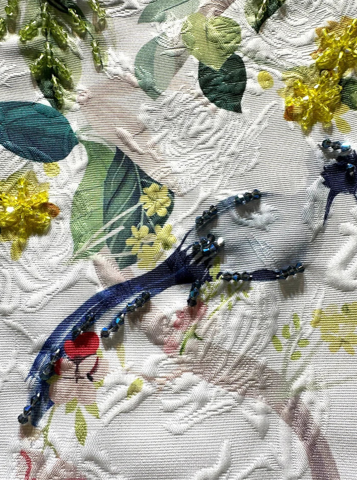 Close-up of embroidered floral patterns with beads and sequins, showcasing intricate details for Robe Imprimée Brodée - DANA - | SuzzaneMarket