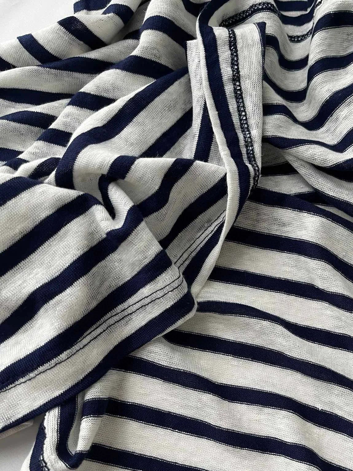 Textured image of a striped fabric in navy and cream, showcasing soft jersey linen material | SuzzaneMarket
