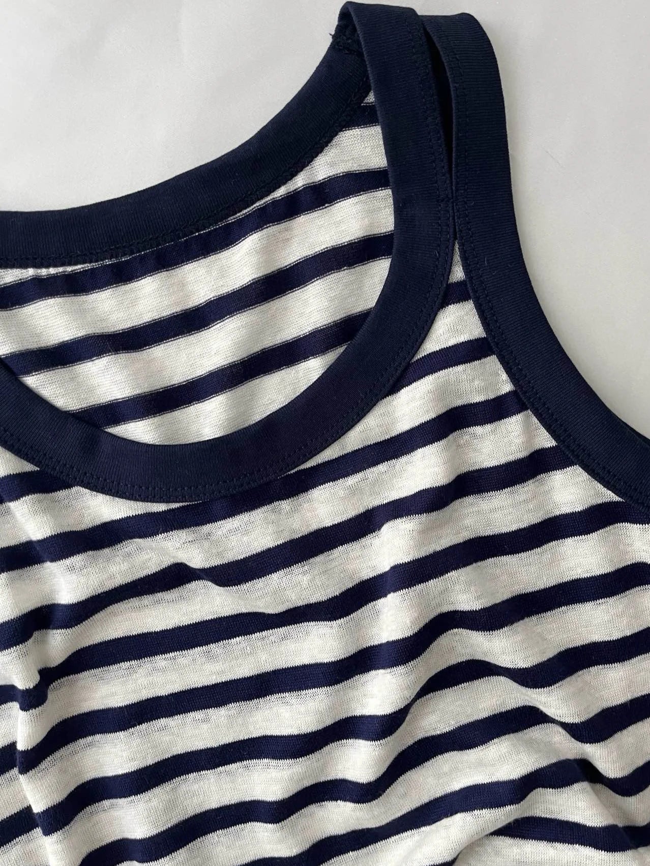 Close-up of navy-striped tank top featuring soft jersey linen material, ideal for casual wear |SuzzaneMarket