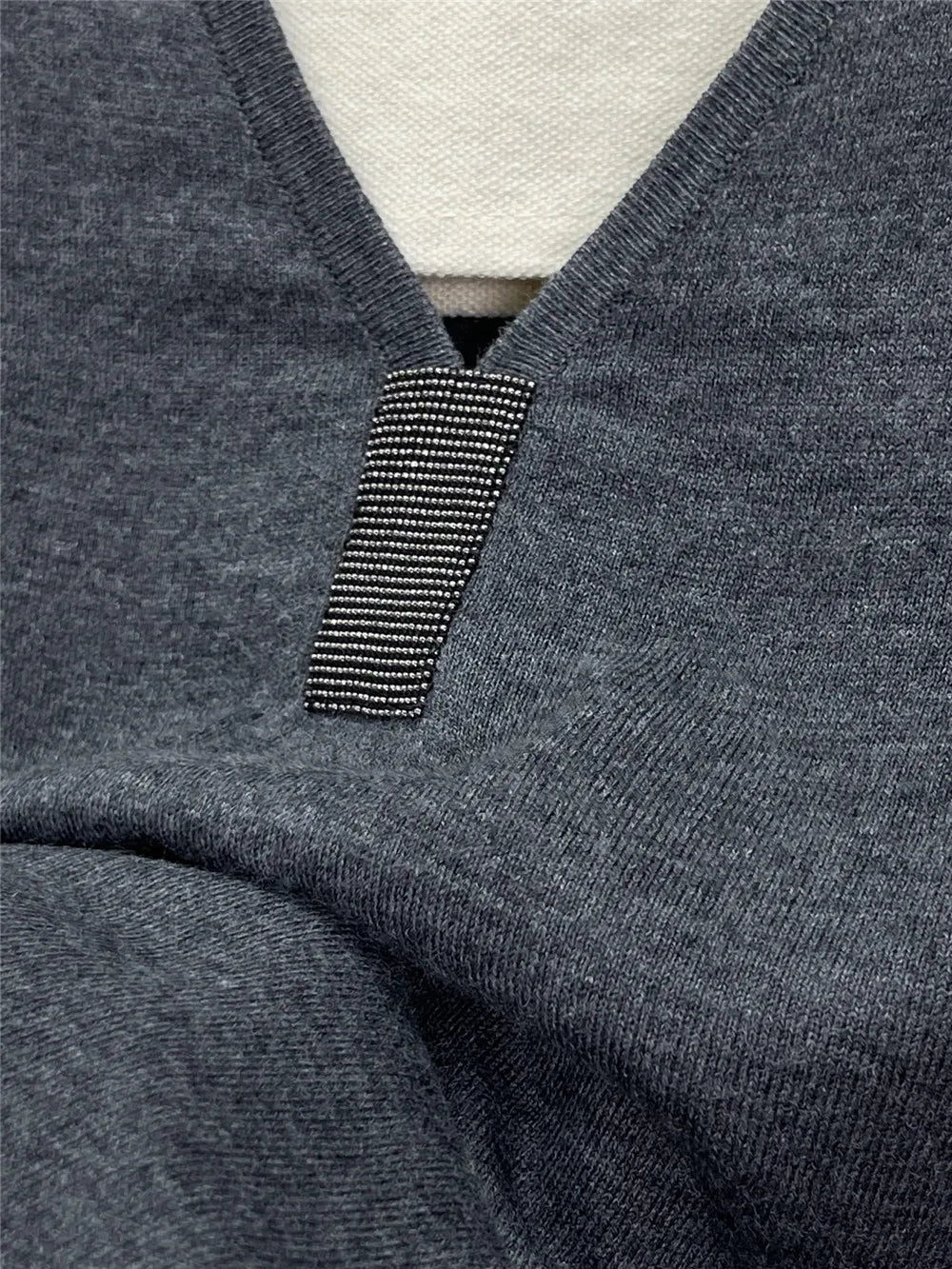 Close-up of V-neck detail with striped embellishment on dark gray fabric - Robe Fine Laine & Soie | SuzzaneMarket