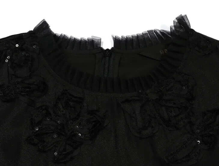 Detail of the neckline featuring delicate sequined embroidery and tulle trim on the Petite Robe Noire dress | SuzzaneMarket