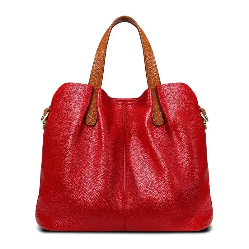 Sac shopping en cuir grainé rouge avec anses en cuir marron, grande capacité et élégant pour un usage quotidien.