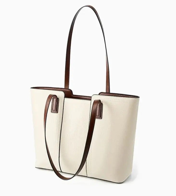 Sac Tote Cuir Grainé en crème avec anses marron, grand et souple, poches intérieures et fermeture zipper, disponible en 9 couleurs.
