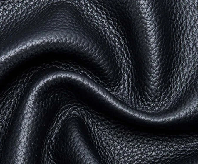 Texture of black grain leather, ideal for stylish phone pouches and accessories.