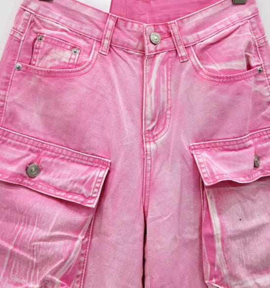 Bermuda Cargo denim in pink, featuring faded look, multiple pockets, and zipper closure. Available at SuzzaneMarket.