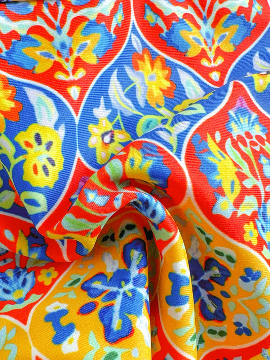 Colorful floral pattern fabric with vibrant reds, blues, and yellows, perfect for summer fashion | SuzzaneMarket