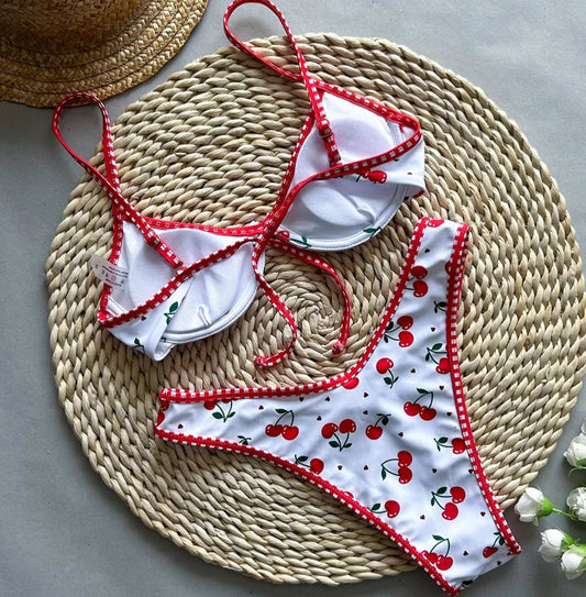 Bikini mini tanga swimsuit with cherry pattern, adjustable straps, and back tie. Perfect for summer beachwear | SuzzaneMarket.