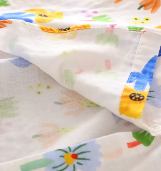Close-up of the colorful floral pattern on a cotton-linen shirt, showcasing its lightweight fabric and unique design | SuzzaneMarket