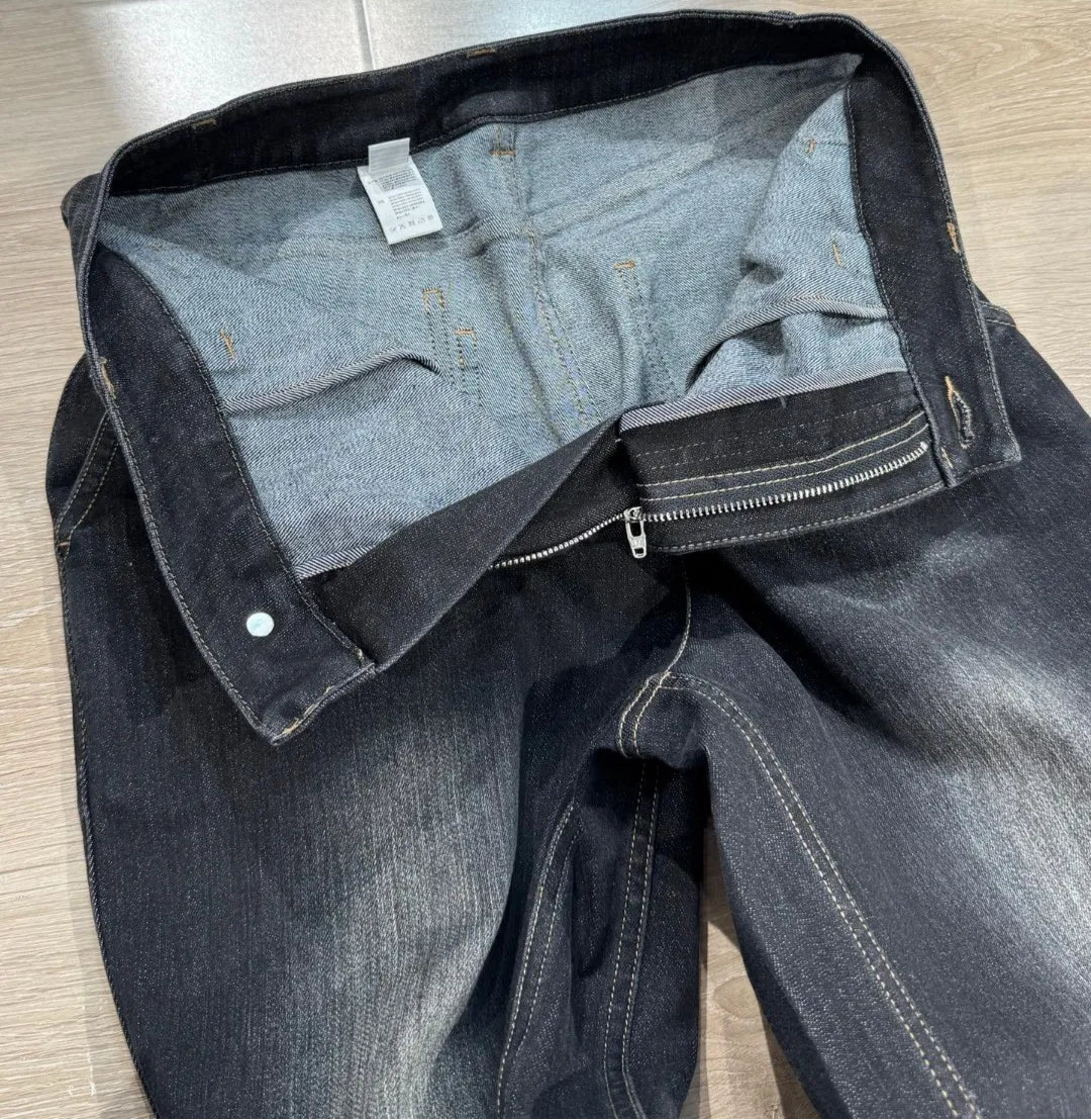 Flared denim jeans with high waist and detailed stitching, showing interior design | SuzzaneMarket