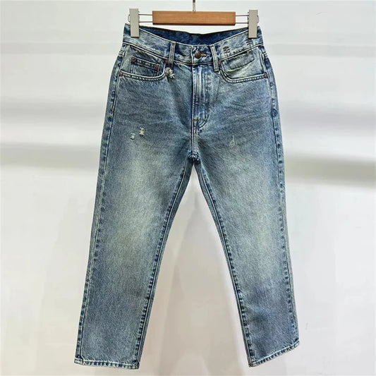 Slim fit denim jeans with a light wash, featuring a high waist and straight legs | SuzzaneMarket