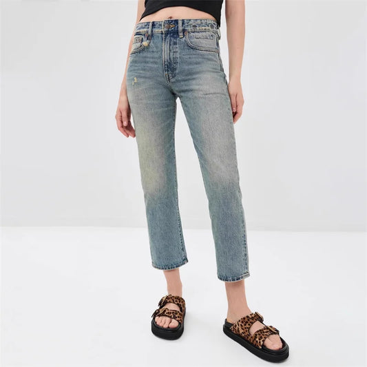 Slim-fit denim jeans in light wash with mid-rise waist, cropped length, styled with trendy leopard sandals | SuzzaneMarket