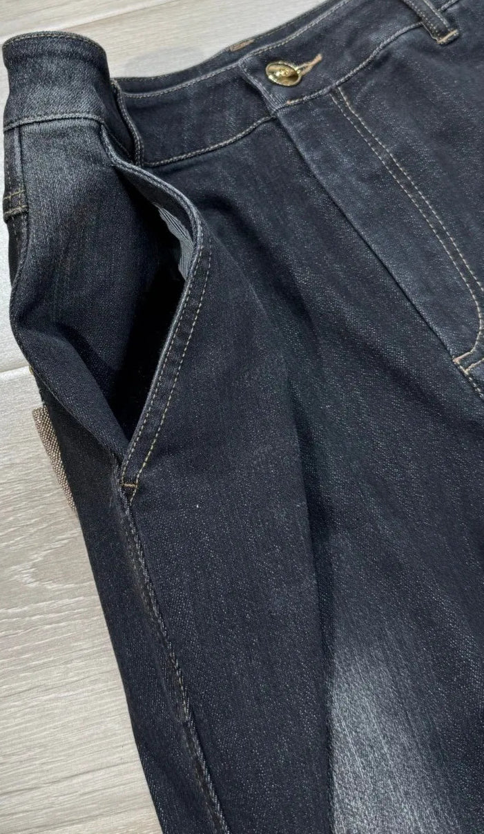 Zoomed view of flared denim jeans with high waist and stretch material, featuring detailed stitching | SuzzaneMarket