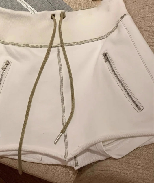 White mini-jupe shorty with elastic waistband and drawstring, featuring side zip pockets |SuzzaneMarket