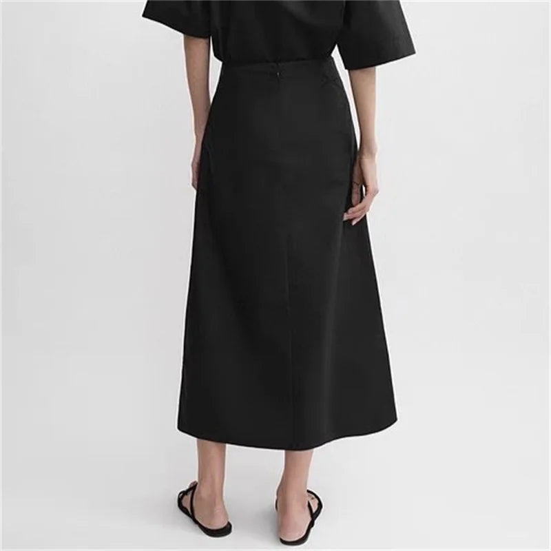 Back view of a classic black popeline skirt with a straight cut and tied waist, perfect for stylish outfits | SuzzaneMarket
