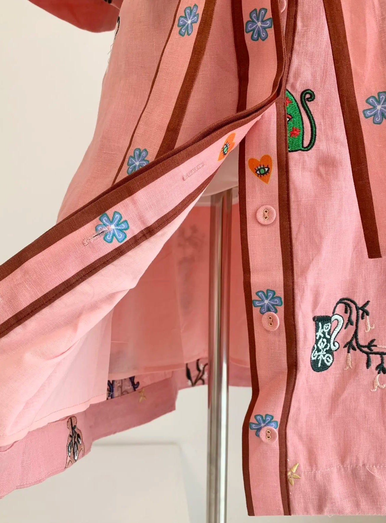 Close-up of the pink embroidered Mini Robe Chemise showcasing its buttons and belt | SuzzaneMarket