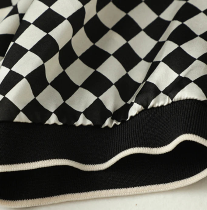 Close-up of the hem of a black and white checkered fabric showing the elastic band | SuzzaneMarket