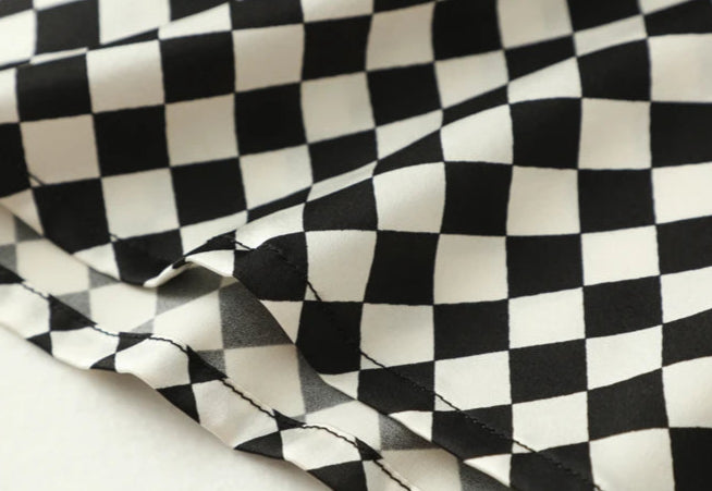 Textured black and white checkered fabric detail for elegant fashion design | SuzzaneMarket