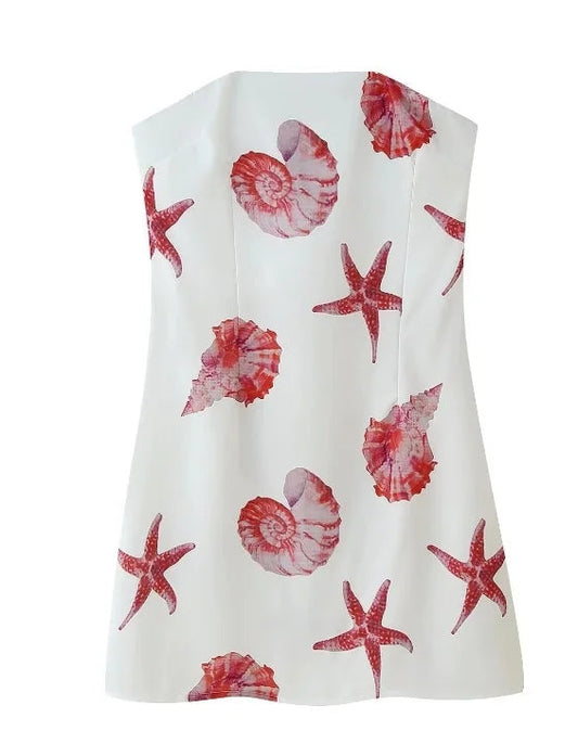 Mini-robe bustier en polyester avec motifs de coquillages et étoiles de mer, fermeture zippée sur le côté.