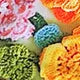 Colorful crochet flowers in 3D fabric design, showcasing vibrant patterns for Mini Brésilien Tanga Floral | SuzzaneMarket
