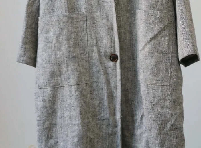 Oversized long linen coat with low sleeves and wrinkle effect, featuring simple button closure and pockets |SuzzaneMarket