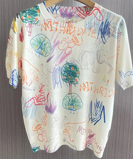 Colorful t-shirt with playful doodles and drawings, featuring a relaxed fit and soft fabric | SuzzaneMarket