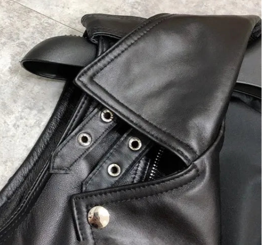 Close-up of biker jacket detailing, showing leather texture, zipper, and buttons | SuzzaneMarket.