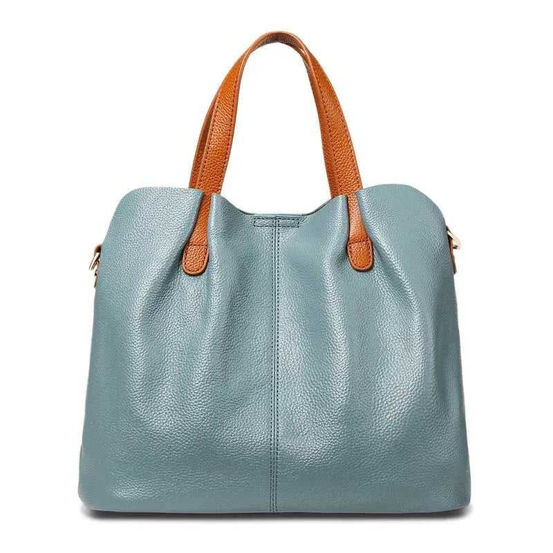 Sac shopping en cuir grainé bleu avec anses en cuir marron, grande capacité pour un usage quotidien.
