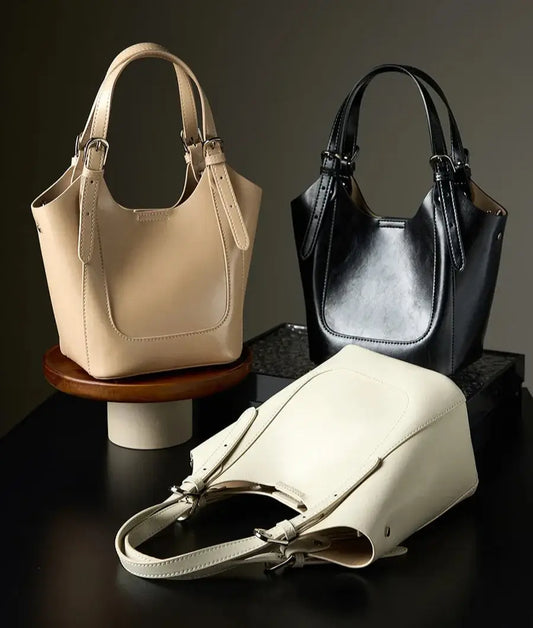 Sceau Cuir Glacé CLEPH in three colors: beige, black, and white, showcasing a stylish design and multiple pockets. SuzzaneMarket.